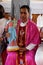 The priest holds a statue of the Virgin Mary with baby Jesus, church in Chunakhali, West Bengal, India