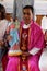 The priest holds a statue of the Virgin Mary with baby Jesus, church in Chunakhali, West Bengal, India