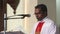 Priest on the podium welcomes parishioners