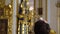 Priest praying in a cathedral, religious ceremony