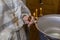 Priest prepare to baptize the child. Font for taking faith.The hands of the priest near the Epiphany bath