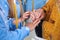 The priest puts the wedding rings on the fingers of the bride and groom at the wedding ceremony in the church