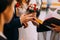 Priest putting golden ring on a bridegroom hand at wedding ceremony in church