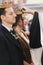 Priest putting on golden wedding crowns on bride and groom heads during holy matrimony in church