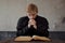 Priest read the Bible. Handsome young catholic priest praying to God