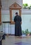 The priest of the Russian Orthodox Church stands in front of the icon of the Holy Blessed Matron of Moscow. Church of the Holy  Ri