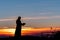 Priest silhoute reading in the sunset light, Romania