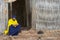 Priest sits at the entrance to the ancient church Ura Kidane Mehret in Bahir Dar, Ethiopia.