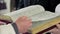 Priest turns the Bible page on a close-up in the church during the ceremony