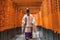 Priest walking through Torii Gates, Fushimi Inari Shrine, Kyoto