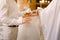 A priest in a white habit marrying the bride and groom in the church of St. Nicholas in Kotor