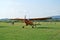 Prijedor, RS, Bosnia and Herzegovina - July 3, 2015: Yellow, orange sport airplane after flight landing on runway, on airfield