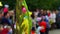 Primary and elementary school children and parents with bouquets of flowers. Defocused blurred image. Bouquet of flowers on the