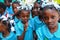 Primary school children gather in schoolyard to watch missionaries.