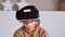 Primary school girl using VR glasses and exploring virtual worlds