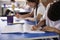 Primary school kids writing at heir desks, close up