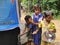 primary school students are washing their hand and their dishes before taking Mid-day meal in a primary school of West Bengal