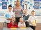 Primary Schoolchildren And Teacher At Desk