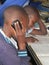 Primary schoolgirl speaking on cellphone in classroom.