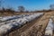 Primer in the sand with the remnants of snow in March.