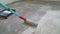 Priming Concrete floor before laying tiles on it, the final preparatory stage for strengthening the surface. Priming the