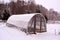 Primitive plastic greenhouse in winter farm garden