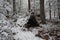 Primitive Winter Tarp Survival Shelter in the Blue Ridge Mountains near Asheville, North Carolina. Bushcraft camp setup in the