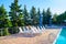 Primorsk, Ukraine. Poolside. Sunbeds near swimming pool surrounded by pine trees