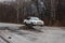 Primorsky Krai, Russia - 2016, autumn - A car drives along a bad, dead road among tall trees. Russian roads. Bad asphalt