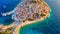 Primosten town, Croatia. View of the city from the air. Seascape with beach and old town. View from drone on the peninsula with ho