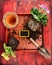 Primula potting with flower pot, scoop,soil and sign on red wooden background