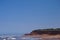 Prince Edward Island, Canada: A red sandstone beach under a clear blue sky