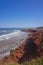 Prince Edward Island, Canada: A red sandstone beach under a clear blue sky