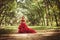 Princess with crown in cloudy red dress