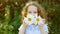 Princess girl with daisy eyes in a summer park. Healthy, medical, happy childhood concept.