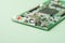 Printed circuit boards PCB with electronic chip components on green background. Minimal industry backdrop