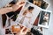 Printed wedding photos with the bride and groom, a vintage black camera and woman hands with photo