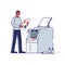 Printing house worker standing at copy machine with photocopy document. Modern polygraphy office