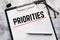 Priorities - word on a piece of paper close up, business creative motivation concept