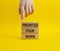 Priority symbol. Wooden blocks with words Prioritize your work. Beautiful yellow background. Businessman hand. Business and