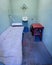 Prison inmates jail cell bed and sink with blue painted walls