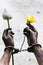 Prisoner hand holding a flower.