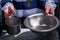 Prisoner`s hands holding aluminum dishes in a hole for supplying