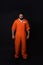 Prisoner in special jumpsuit on black background