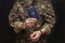 A prisoner of war in handcuffs holds a Belarusian passport in his hands, selective focus. Geneva Convention, humane treatment of p