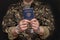 A prisoner of war in handcuffs holds a Belarusian passport in his hands, selective focus. Geneva Convention, humane treatment of p