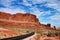 Pristine, curved road winding through a desert landscape with steep cliffs in Utah, USA