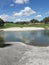 Pristine Golf Course Landscape Scene with White Sand, Fluffy Clouds, Lake Reflection