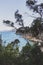 Pristine little beach surrounded by rocky cliffs with turquoise water from the Pacific Ocean, seen along the Boronia Beach coastal