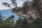 Pristine little beach surrounded by rocky cliffs with turquoise water from the Pacific Ocean, seen along the Boronia Beach coastal